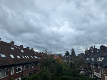 Beautiful view of buildings and trees in city on cloudy day