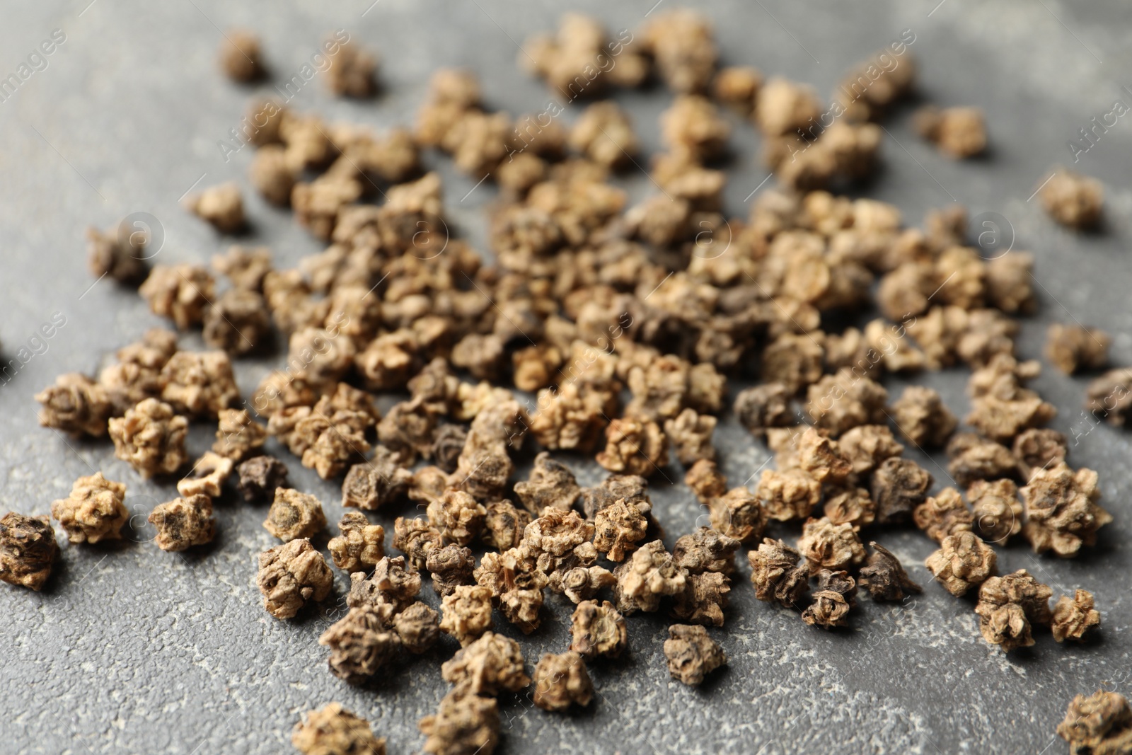 Photo of Raw beet seeds on grey background, closeup. Vegetable planting