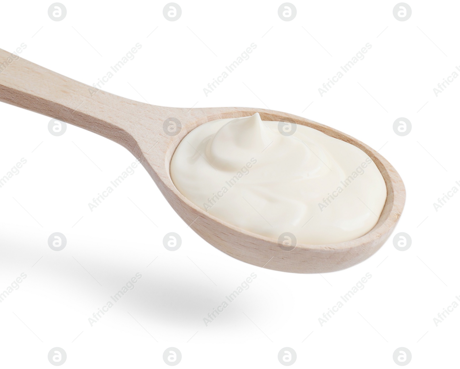 Photo of One wooden spoon with mayonnaise isolated on white