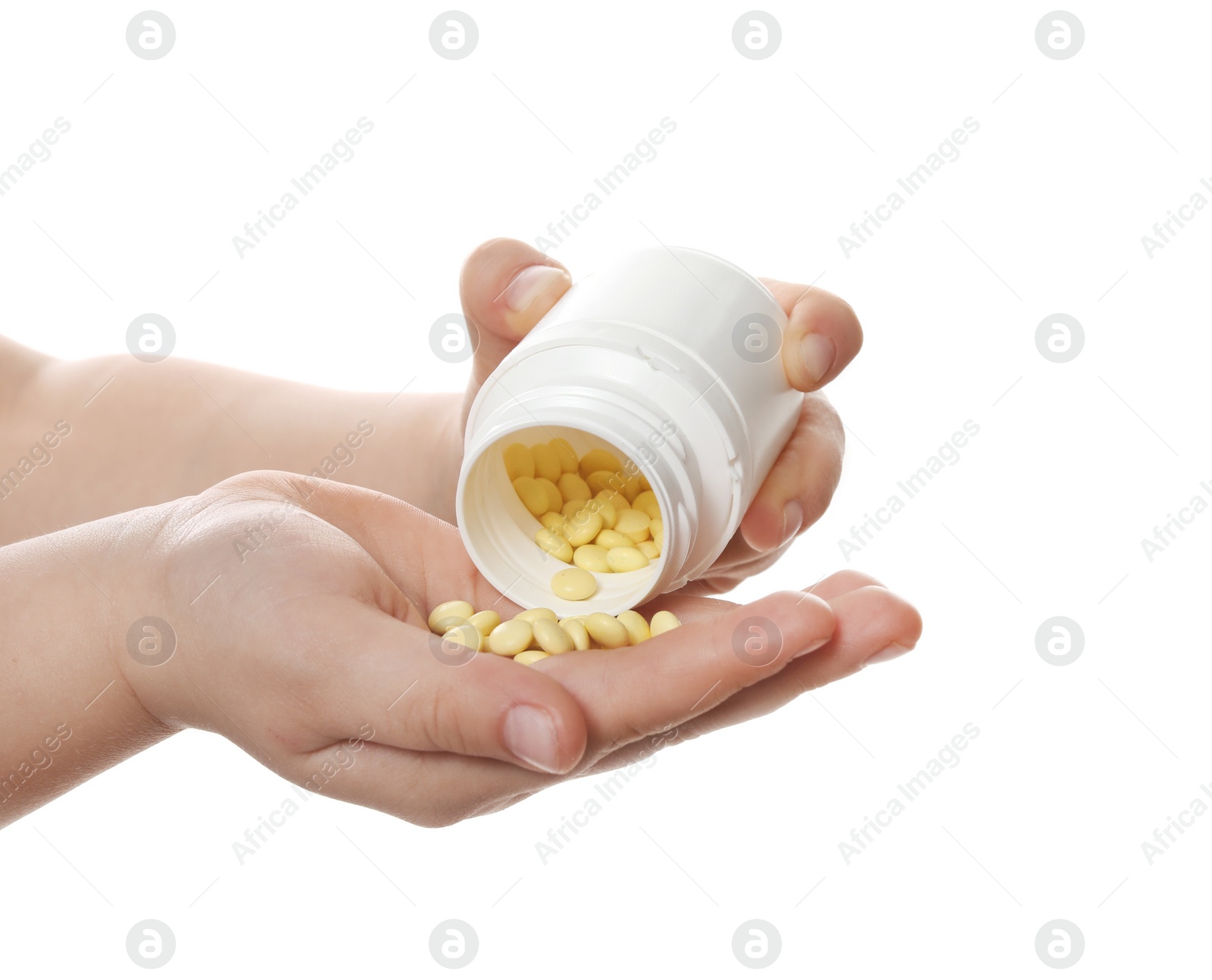 Photo of Little child with pills on white background, closeup. Danger of medicament intoxication