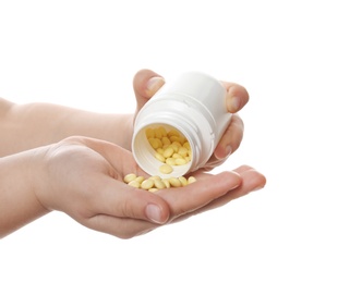 Photo of Little child with pills on white background, closeup. Danger of medicament intoxication