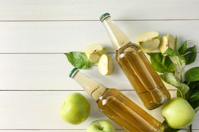 Flat lay composition with delicious apple cider on white wooden table, space for text