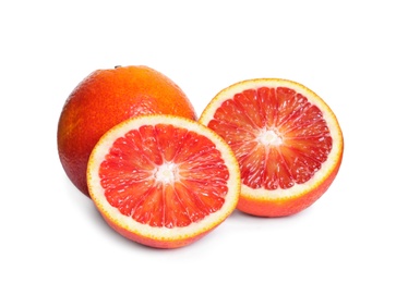 Whole and cut red oranges on white background