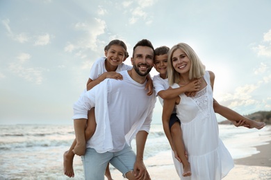 Happy family on beach near sea. Summer vacation