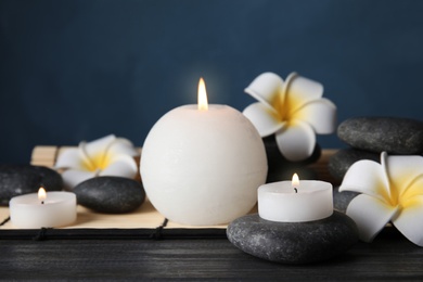 Spa stones, candles and flowers on table