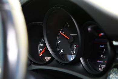 Photo of Speedometer and tachometer inside of modern car, closeup