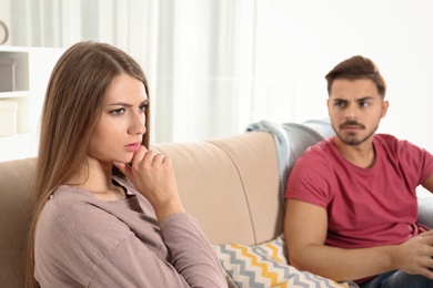 Photo of Young couple with relationship problems in living room