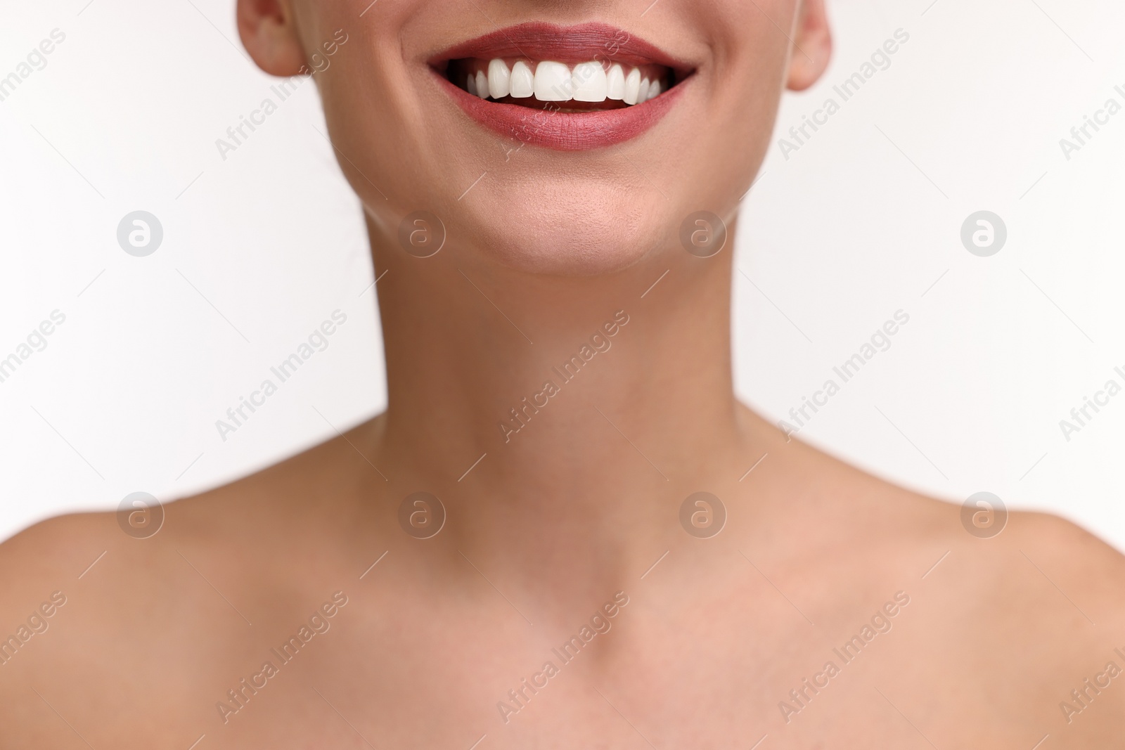 Photo of Woman with beautiful lips smiling on white background, closeup