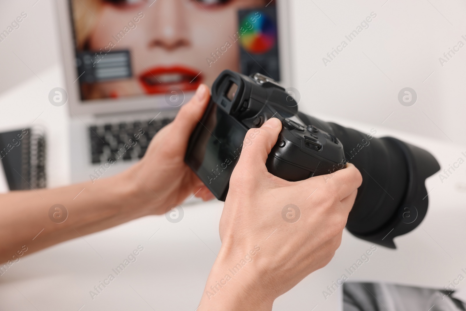 Photo of Professional photographer with digital camera indoors, closeup