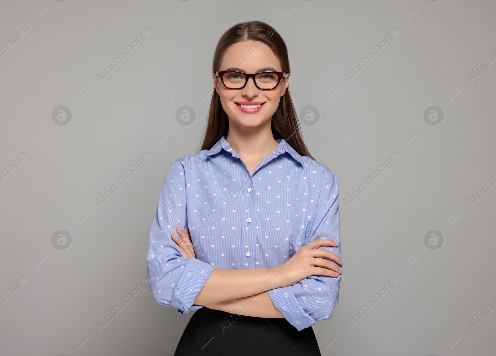 Photo of Portrait of beautiful young teacher on grey background