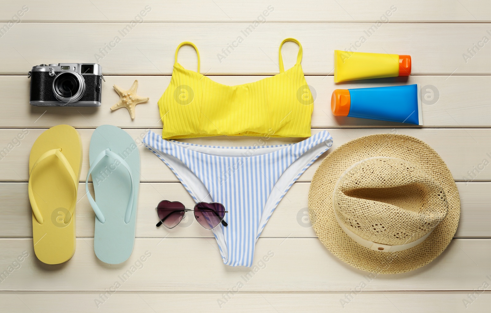 Photo of Different beach objects on white wooden background, flat lay