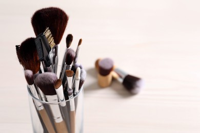 Photo of Set of professional brushes on table, closeup. Space for text