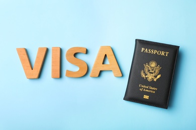 Flat lay composition with word VISA and passport of USA on color background