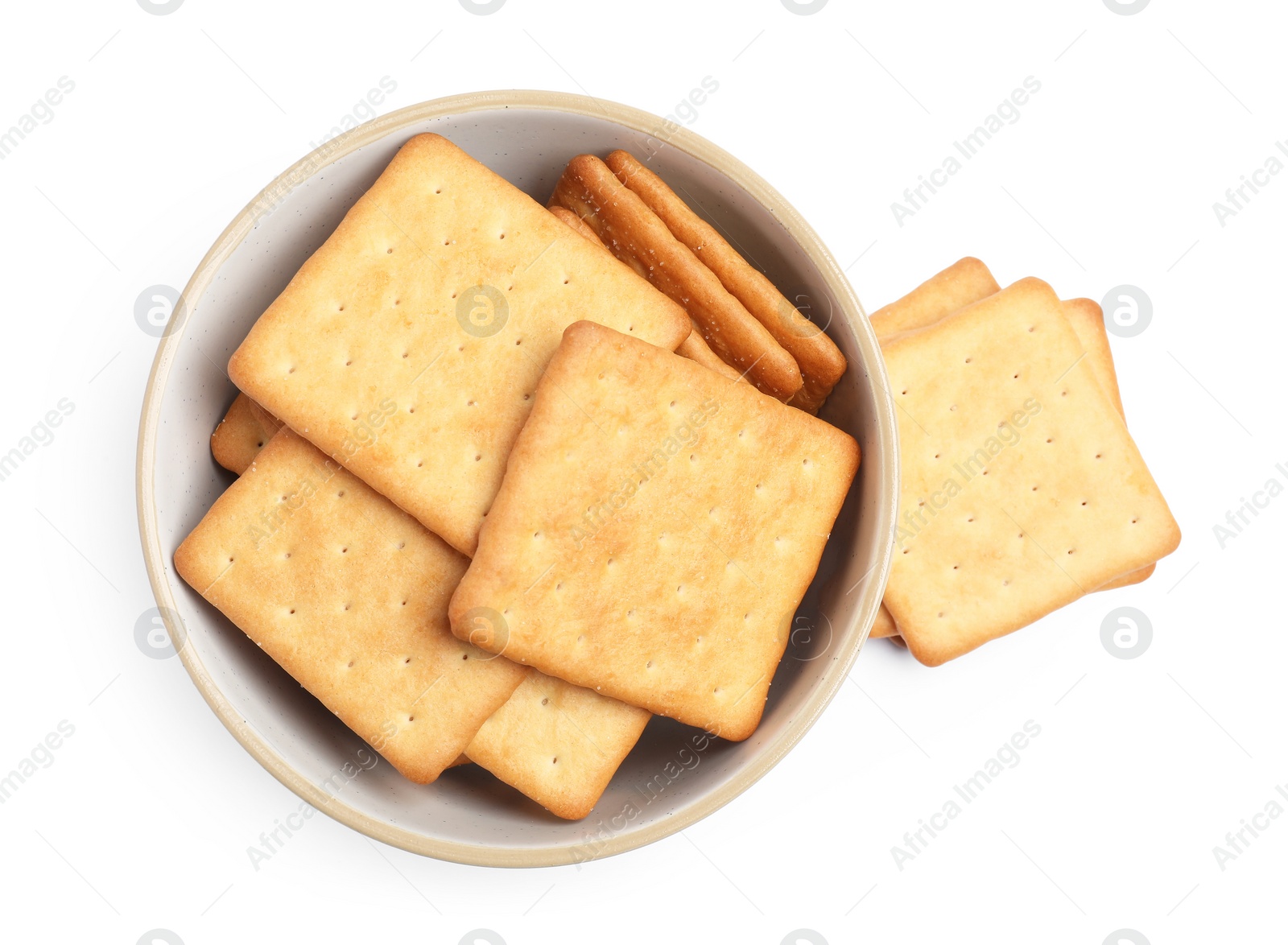 Photo of Tasty crackers in bowl isolated on white, top view