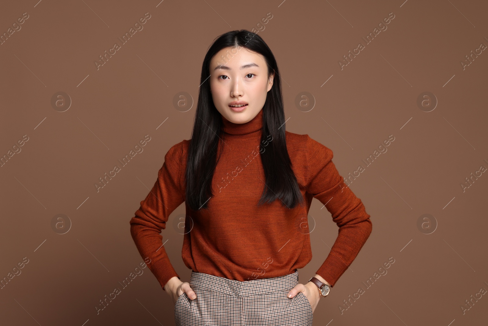 Photo of Portrait of beautiful woman on brown background