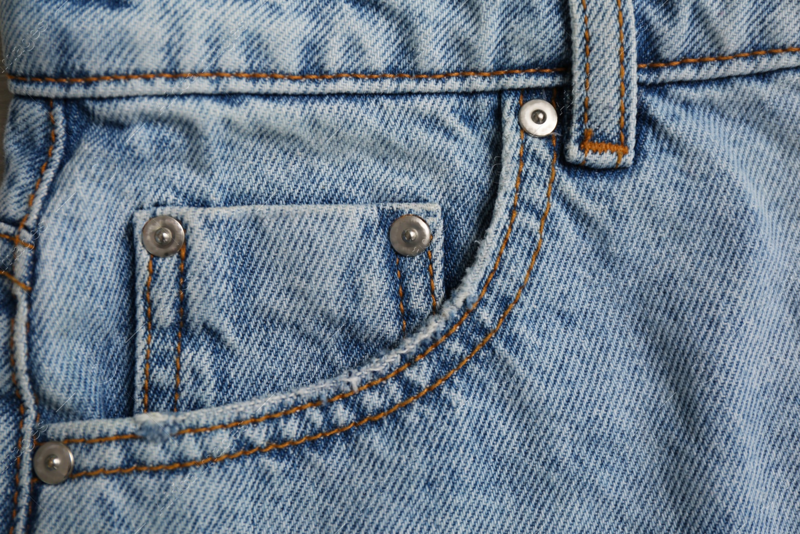 Photo of Light blue jeans with inset pocket as background, closeup