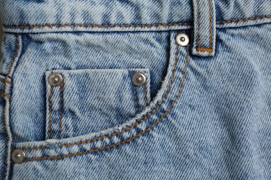 Light blue jeans with inset pocket as background, closeup