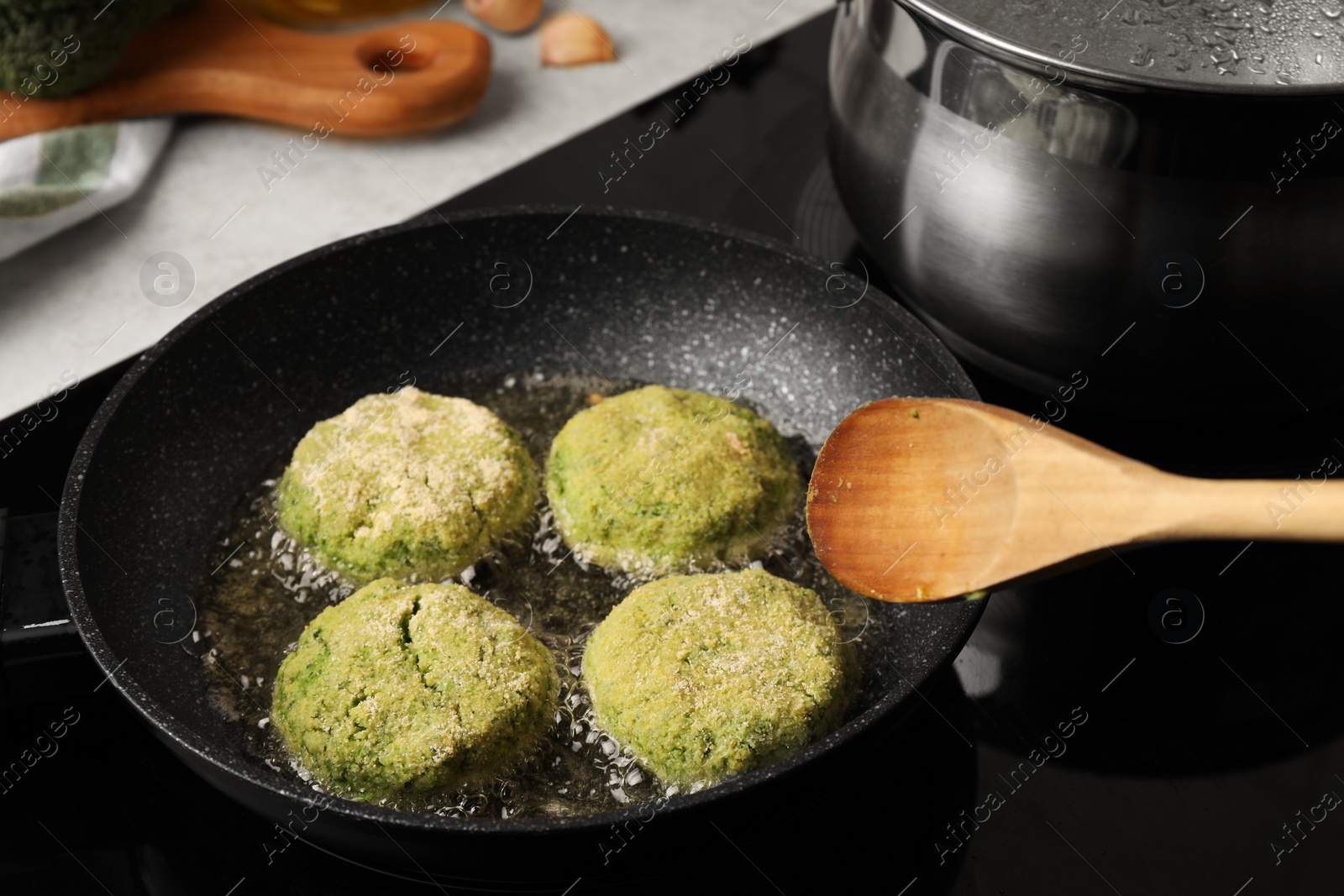 Photo of Cooking vegan cutlets in frying pan on stove