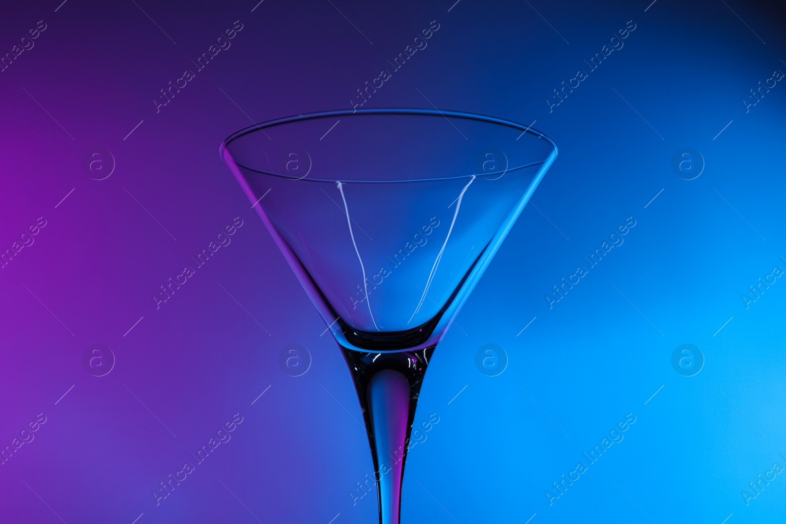 Photo of Empty clean martini glass in neon lights