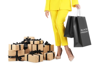 Photo of Woman with shopping bags and gift boxes on white background, closeup. Black Friday Sale