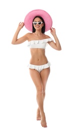 Photo of Beautiful young woman in stylish bikini with hat on white background