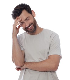 Embarrassed man covering face with hand on white background