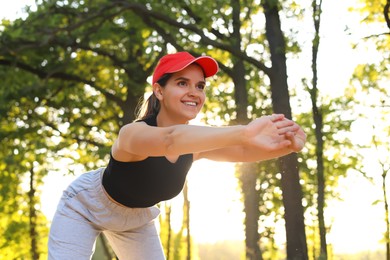 Young woman doing morning exercise in park