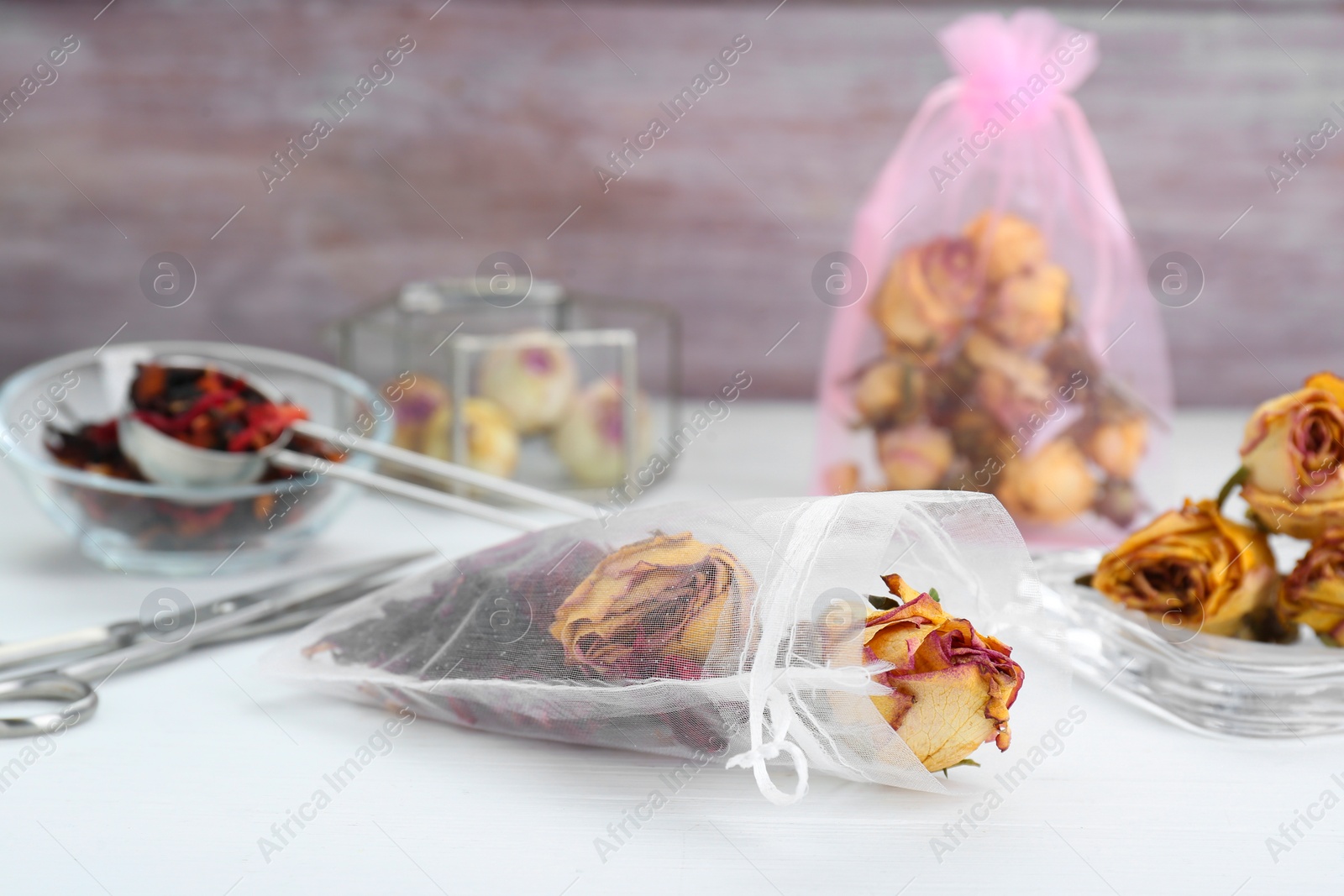 Photo of Scented sachet with dried flowers on white table