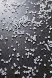 Photo of Scattered white natural salt on black table