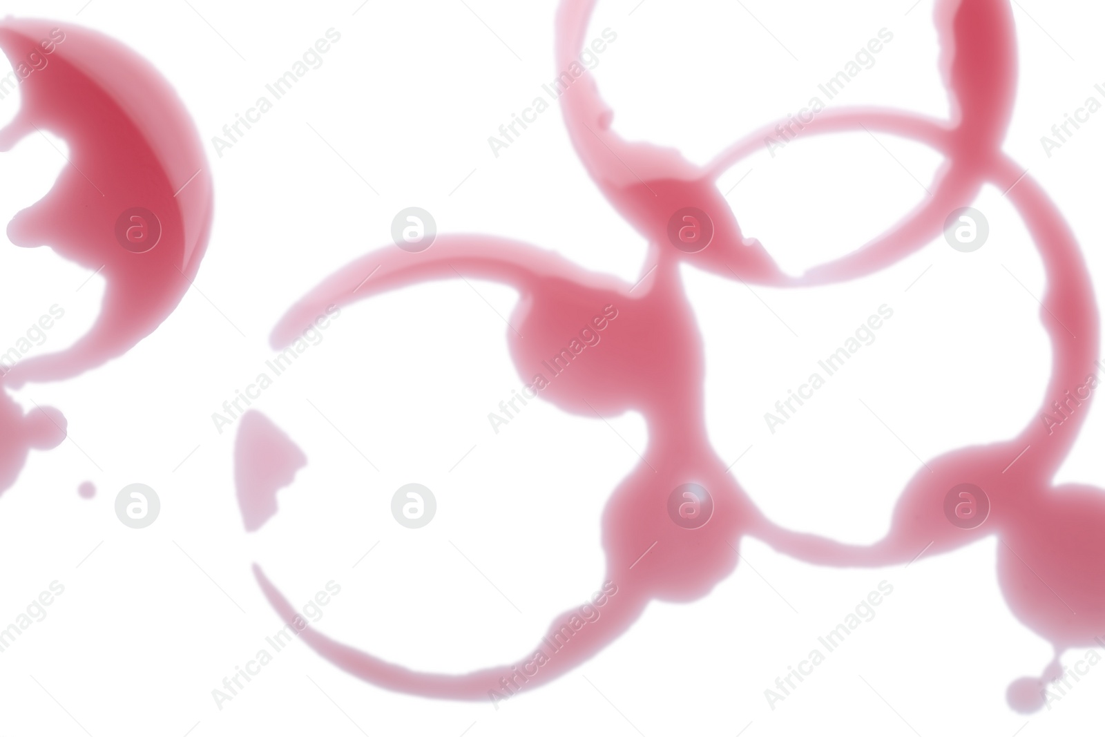 Photo of Red wine rings on white background, top view