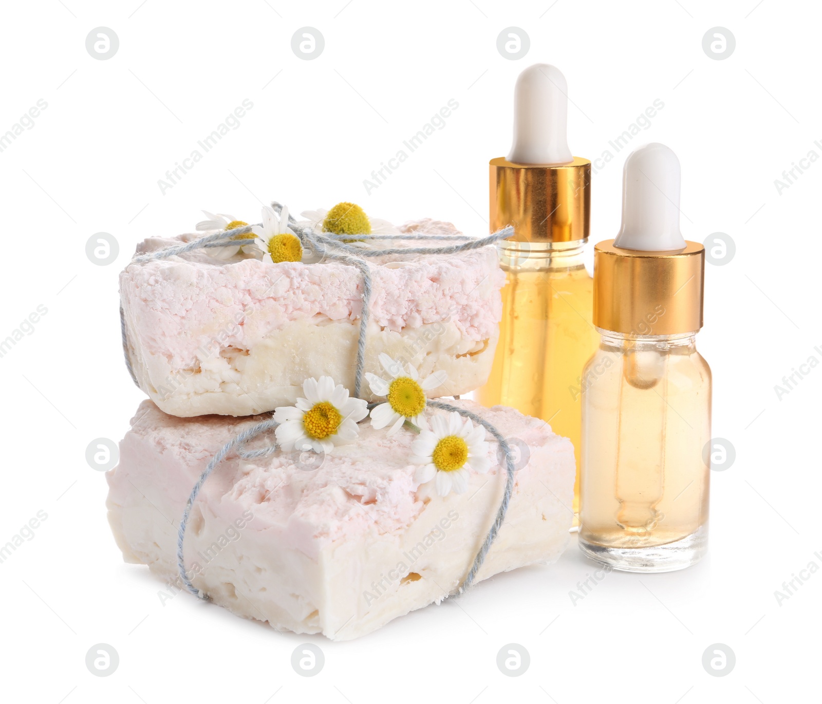 Photo of Chamomile flowers, soap bars and cosmetic products on white background