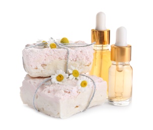 Photo of Chamomile flowers, soap bars and cosmetic products on white background