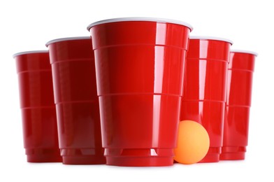 Photo of Plastic cups and ball for beer pong on white background