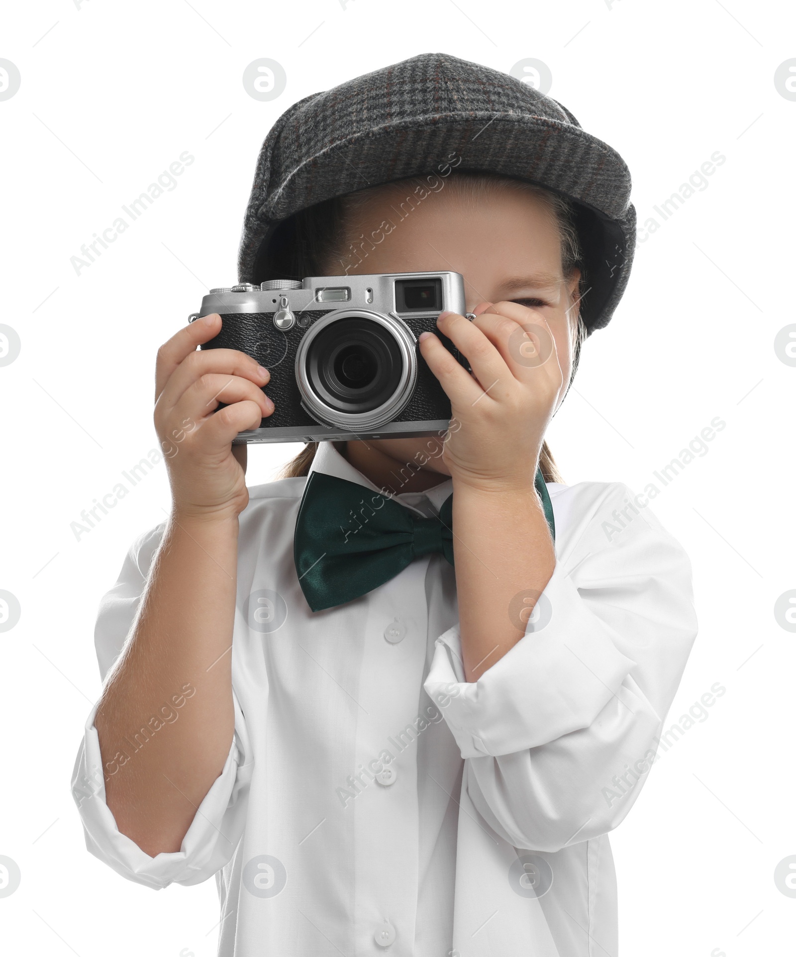 Photo of Cute little detective taking photo with vintage camera on white background