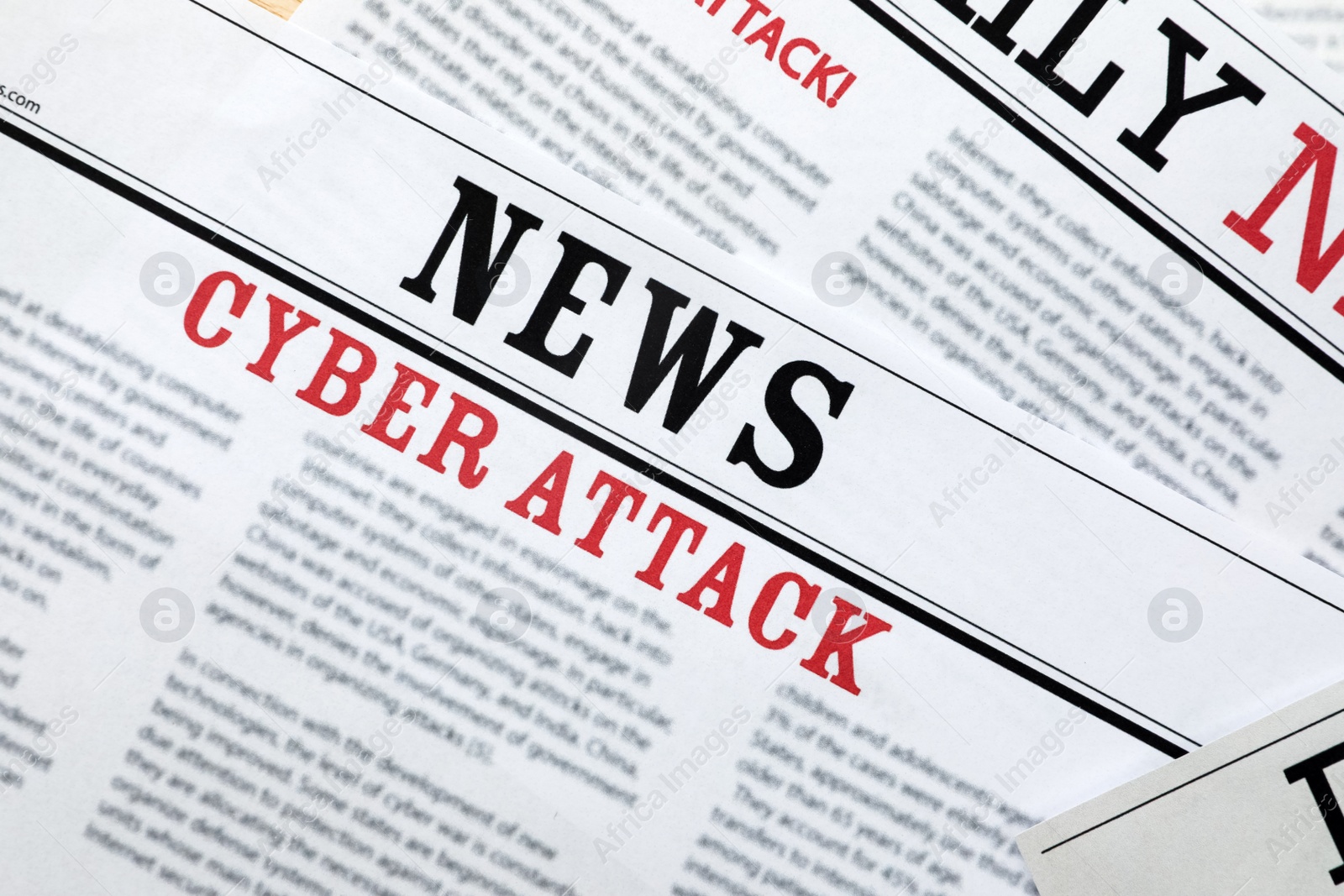Photo of Newspapers with headlines Cyber Attack as background, closeup