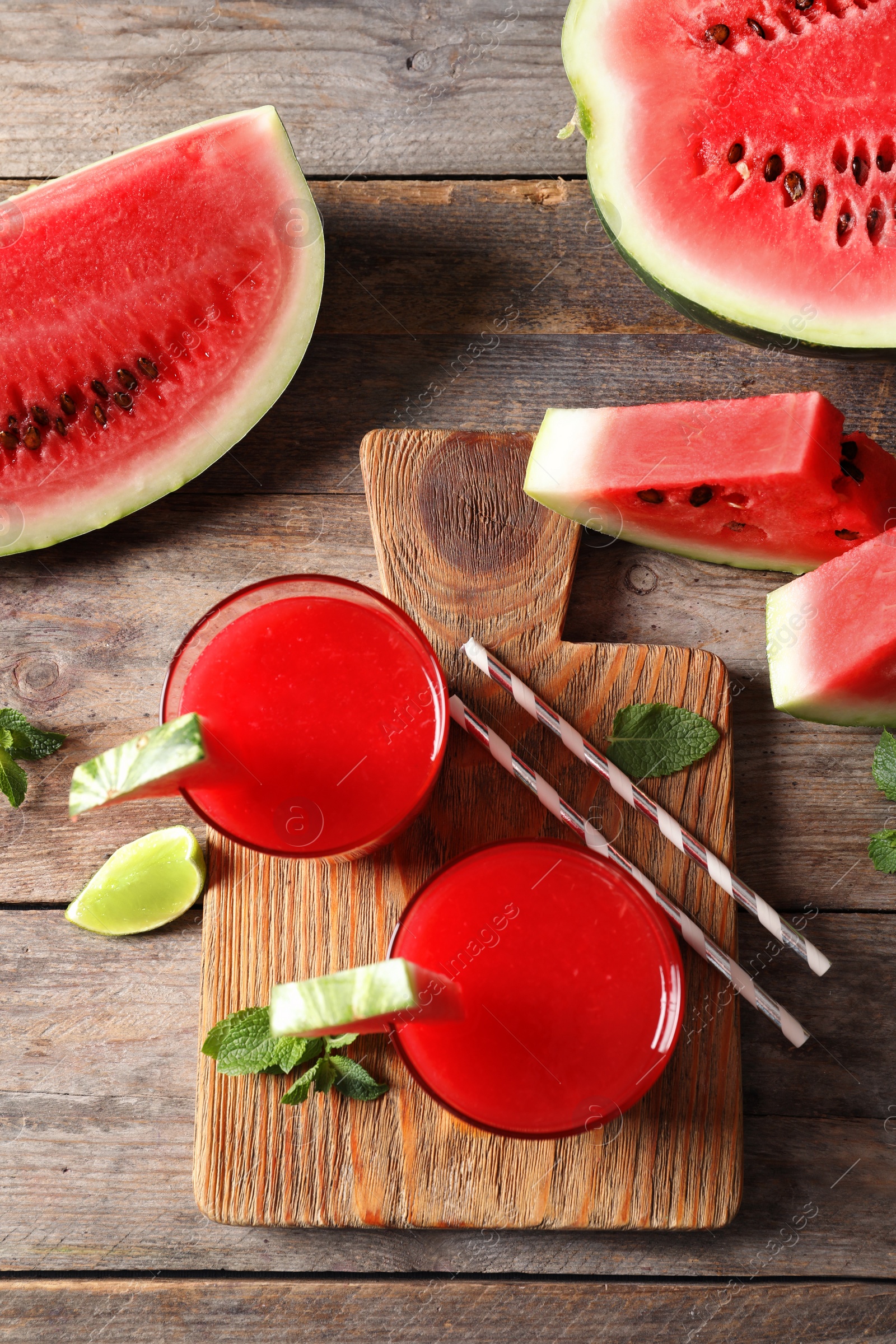 Photo of Summer watermelon drink in glasses served on table, top view