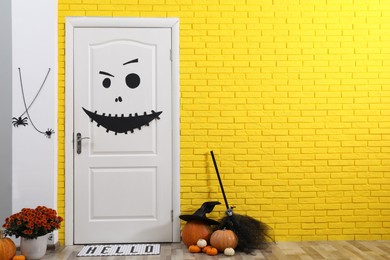 Stylish hallway interior with different Halloween decor, space for text