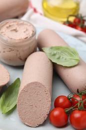 Delicious liver sausages, paste and cherry tomatoes on table, closeup