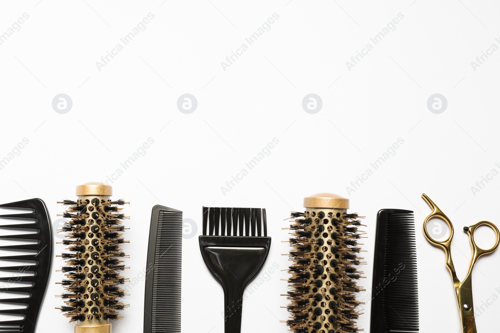 Photo of Hairdressing tools on white background, flat lay. Space for text