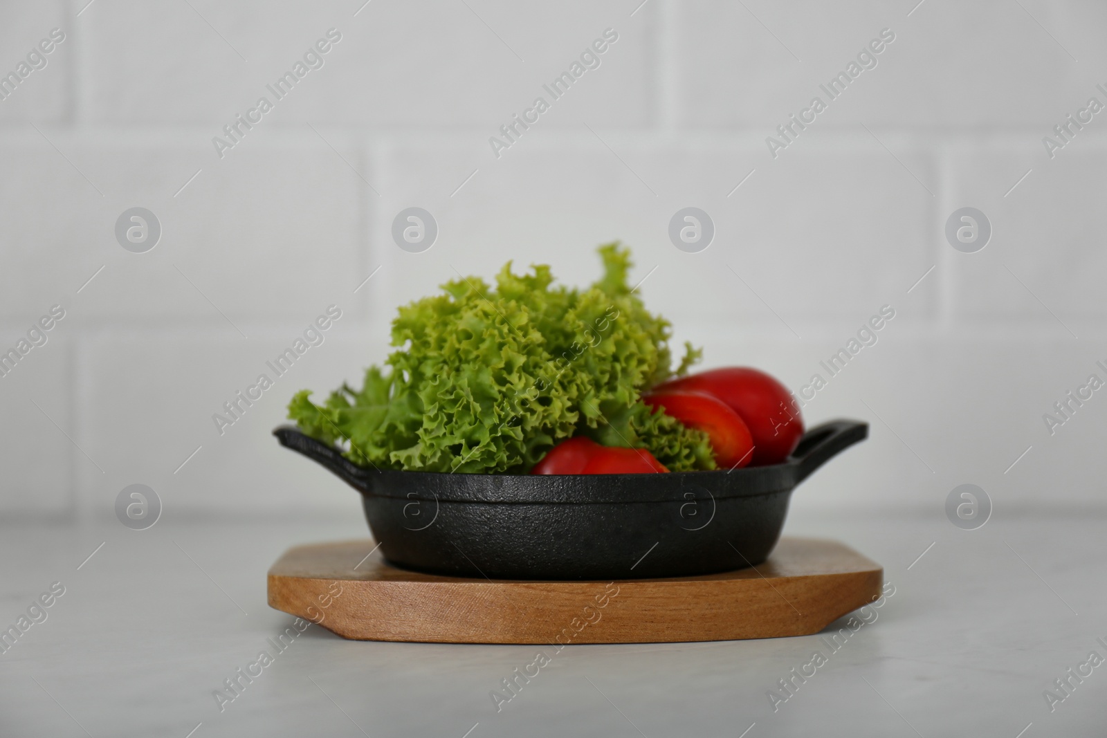 Photo of Portioned frying pan with products on table