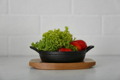 Portioned frying pan with products on table