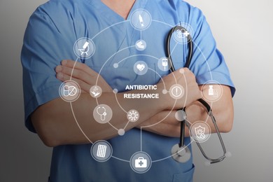 Doctor with stethoscope on light grey background, closeup. Concept of antibiotic resistance