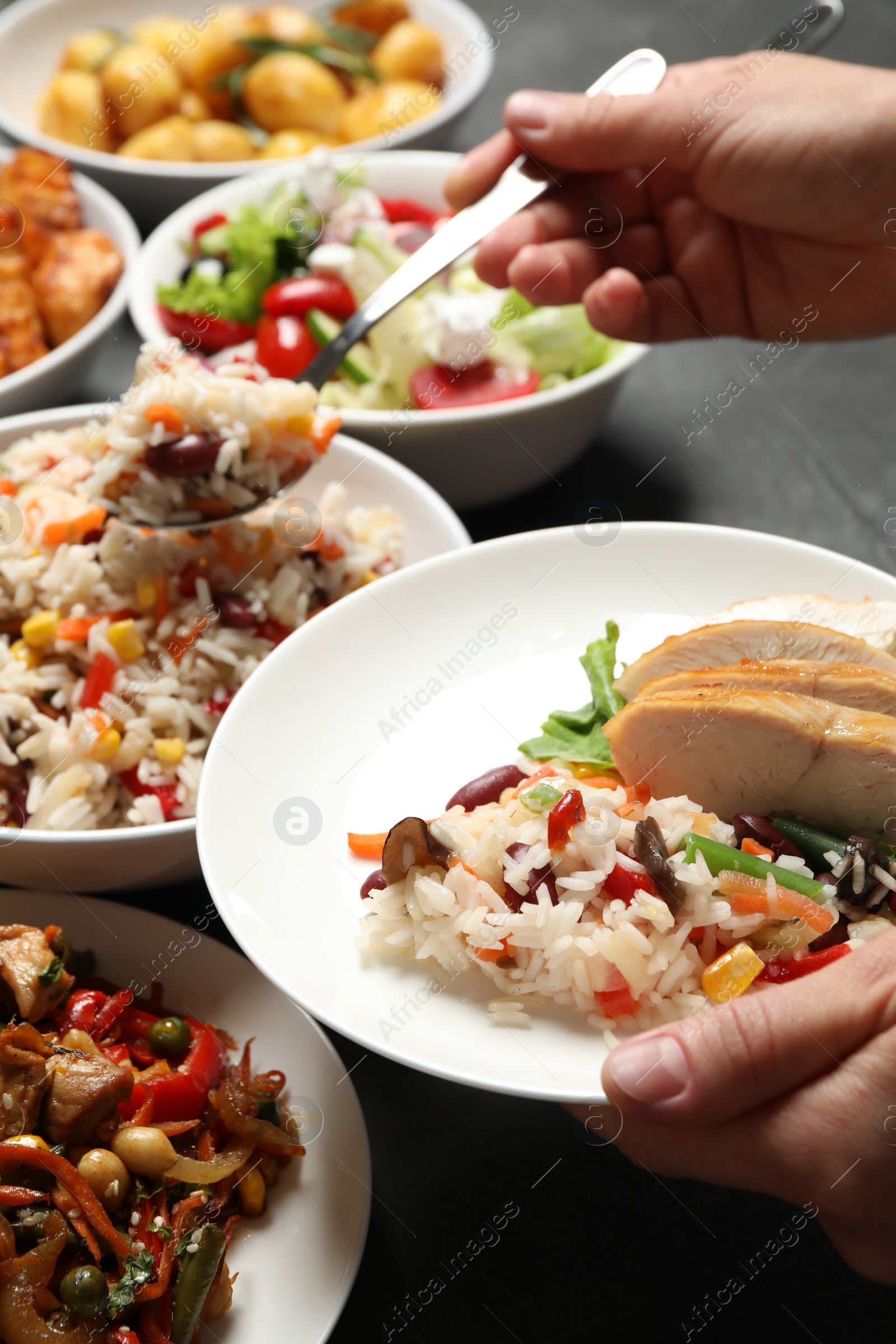 Photo of Woman taking food from buffet table, closeup