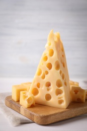 Photo of Board with tasty fresh cheese on white table