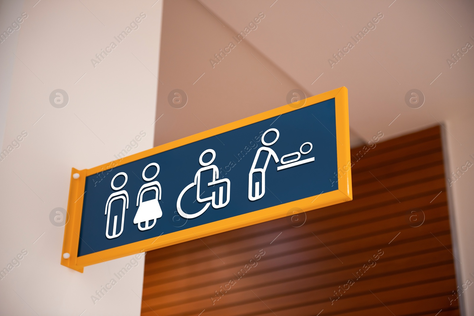 Image of Blue public toilet sign on wall indoors