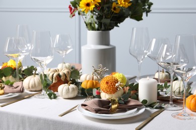 Photo of Beautiful autumn table setting with bouquet indoors. Plates, cutlery, glasses and floral decor