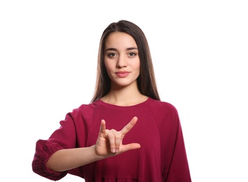 Photo of Woman showing I LOVE YOU gesture in sign language on white background