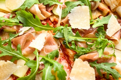 Photo of Tasty pizza with meat and arugula as background, closeup