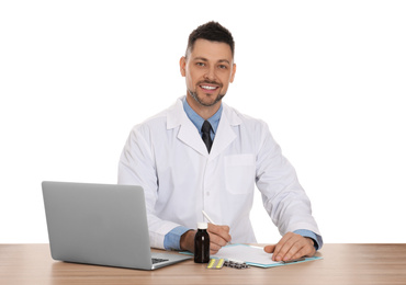 Professional pharmacist working at table against white background