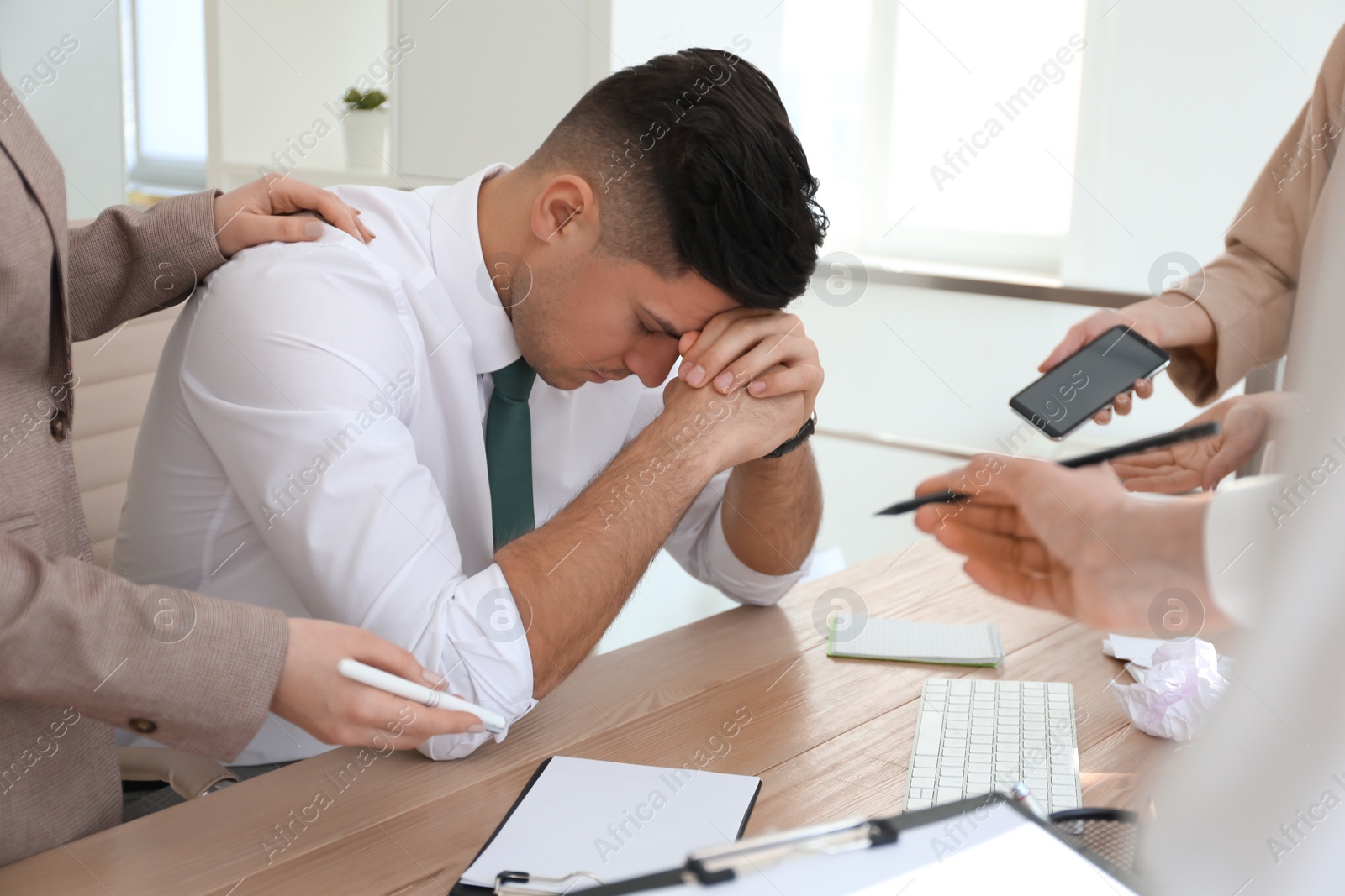 Photo of Businessman stressing out at workplace in office